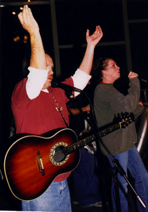 Jim lifting hands to Heaven